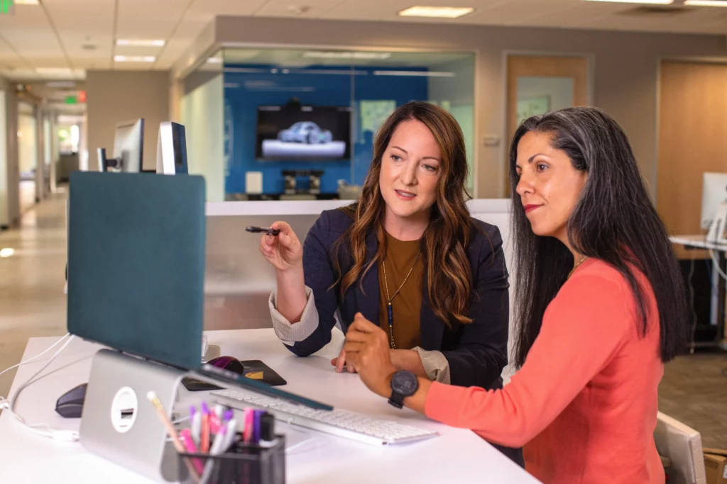 2 women discussing a candidate profile